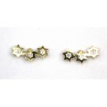 A pair of 9ct yellow gold diamond set triple star stud earrings, L. 0.7cm.