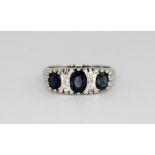 An 18ct white gold sapphire and diamond set ring, approx. 5.7gr, (O).