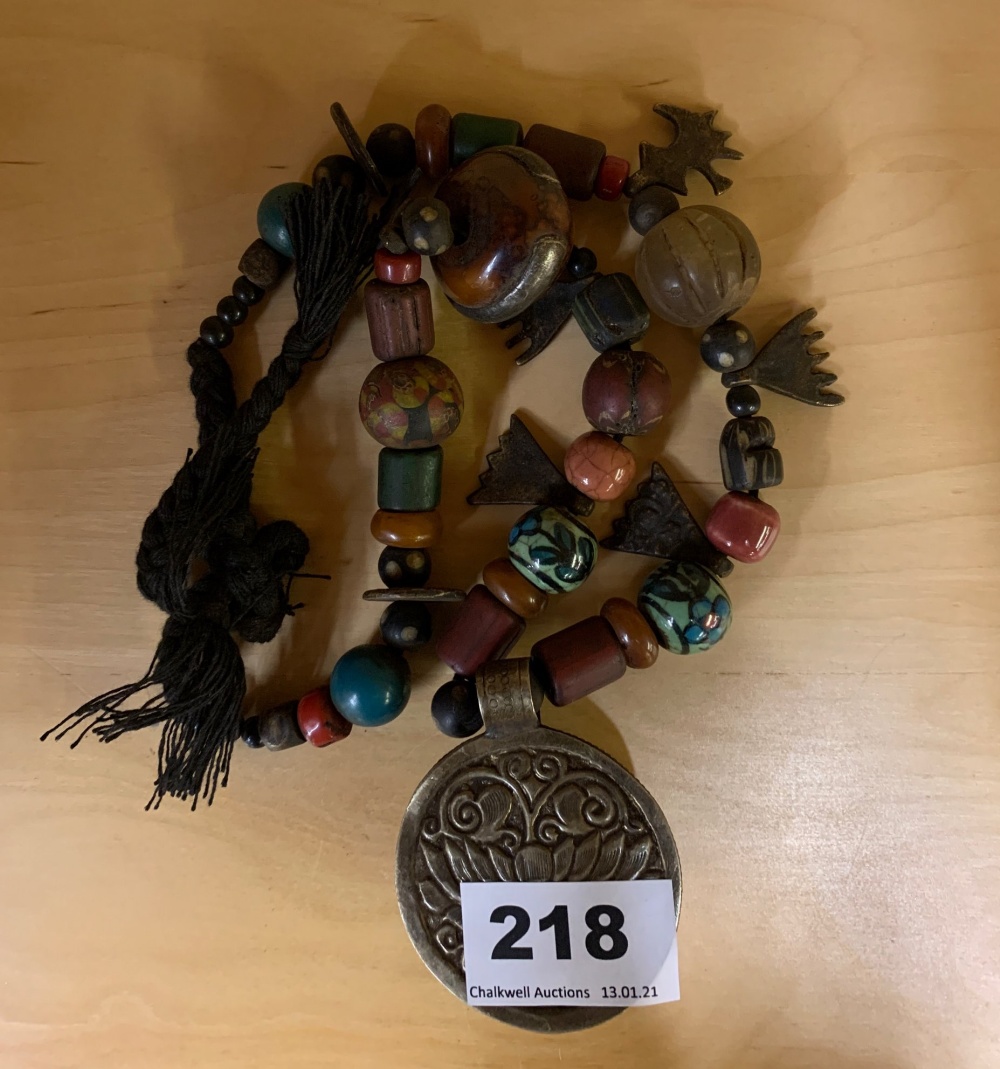 An interesting Tibetan necklace of sacred and memorable objects collected on a pilgrimage, folded L.