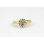 A 9ct yellow gold diamond set cluster ring, (P).