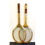 Two vintage tennis rackets and two cricket bats.