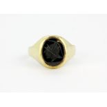 A 9ct yellow gold signet ring set with carved hematite, approx. 3.3gr, (S).