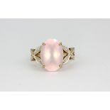 A 9ct yellow gold ring set with large oval cut rose quartz and diamond set shoulders, (O).