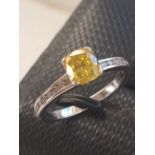 An 18ct white gold solitaire ring set with a fancy brownish yellow cushion cut diamond and diamond