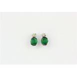 A pair of 14ct white gold (stamped 585) stud earrings set with round cut emeralds and diamonds, L.