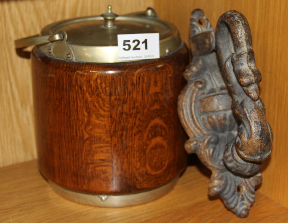 A heavy cast iron door knocker and an oak biscuit barrel.