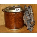 A heavy cast iron door knocker and an oak biscuit barrel.