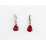 A pair of 925 silver drop earrings set with pear cut rubies and white stones, L. 1.5cm.