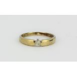 A 9ct yellow gold (stamped 9ct) diamond set solitaire ring, (L).