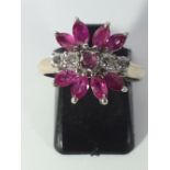 An 18ct white gold ring set with marquise cut fancy pink sapphires and diamonds, (M).