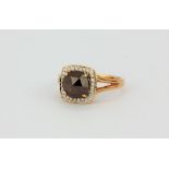 An unusual hallmarked 18ct rose gold ring set with a rose cut fancy champagne diamond surrounded