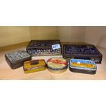 A group of mixed vintage advertising tins.