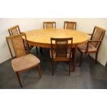 A 1970's G-PLAN teak dining table and six chairs with cane backs, 158 x 108cm.