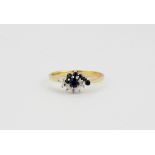 An 18ct yellow and white gold sapphire and diamond set cluster ring, approx. 1.2gr, (M).