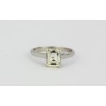 A hallmarked 18ct white gold ring set with a bright emerald cut diamond (approx 1.7ct). (N)