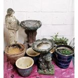 A collection of vintage concrete garden ornaments and pots.