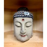 A Chinese carved wooden and painted Buddha head, H. 31cm.