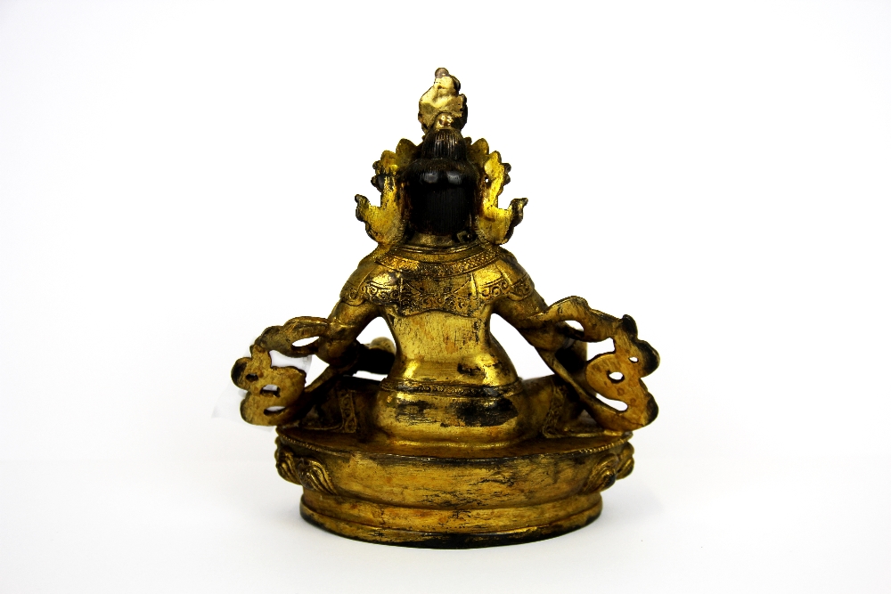 A Tibetan gilt bronze figure of a seated Deity, H. 15cm. - Image 2 of 3