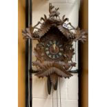 A large early 20th Century Black Forest carved cuckoo clock, H. 70cm.