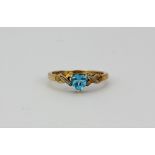 A 9ct yellow gold ring set with a heart cut blue topaz and diamond set shoulders, (K.5).