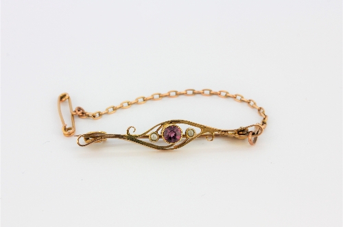 A boxed antique yellow metal (tested minimum 9ct gold) pink tourmaline and seed pearl set brooch, L.