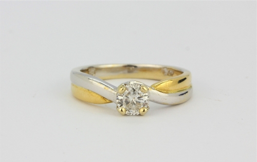 An 18ct yellow and white gold (stamped 18ct) brilliant cut diamond set solitaire ring, approx. 0.