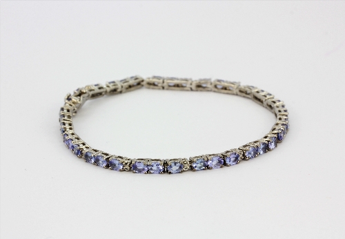 A 925 silver tanzanite and white topaz set bracelet with certificate, L. 20cm.