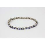 A 925 silver tanzanite and white topaz set bracelet with certificate, L. 20cm.