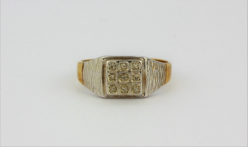 A gentleman's 9ct yellow and white gold diamond set signet ring, (U.5).