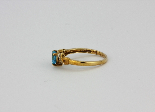 A 9ct yellow gold ring set with a heart cut blue topaz and diamond set shoulders, (K.5). - Image 2 of 2