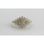 A 9ct yellow and white gold diamond set cluster ring, approx. 0.75ct, (K.5).