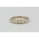 An 18ct white gold diamond set half eternity ring approx. 0.70ct, (K).