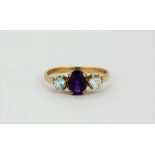 A 9ct yellow gold ring set with oval cut amethyst and blue topaz, (M).