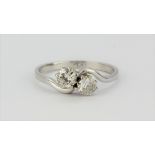 A platinum diamond set crossover ring, approx. 0.60ct, (N).