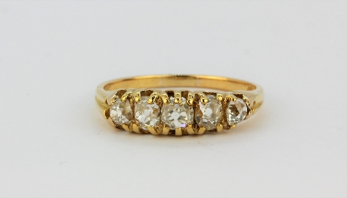 An 18ct yellow gold (stamped 18ct) set with old cut diamonds, approx. 1.25ct, (S).