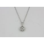 An 18ct white gold (stamped 750) diamond set halo pendant and chain, centre diamond approx. 1ct,