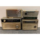 Four vintage portable radios.