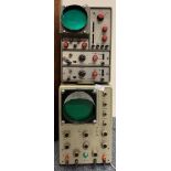 Two vintage metal cased oscilloscopes.