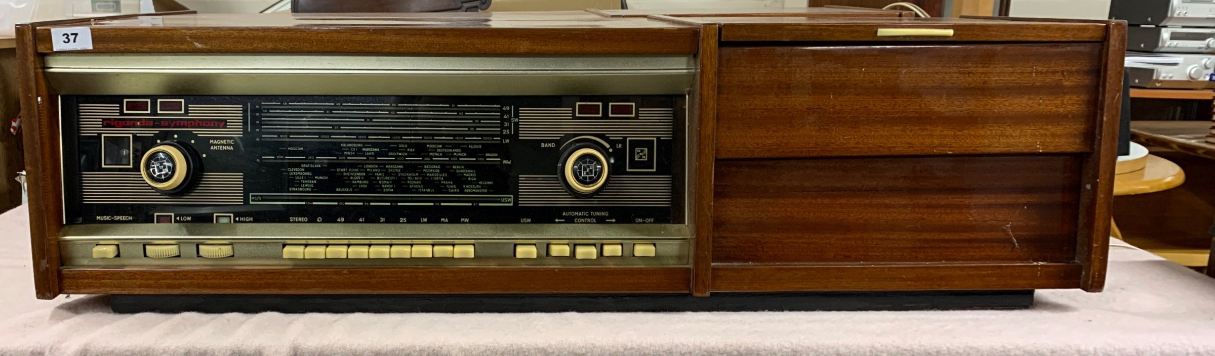 A Rigonda Symphony stereo-radio phonograph, 43.5cm x 11.5cm x 13cm.