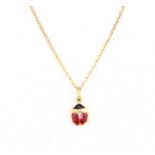 An 18ct yellow gold (stamped 750) enamelled ladybird shaped pendant and chain, L. 1.5cm.