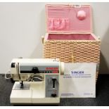 A vintage Singer featherweight sewing machine and woven carrying case.