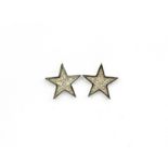 A pair of 18ct white gold diamond set star shaped earrings.