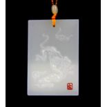 A Chinese carved white jade amulet of a tiger on white jade bead necklace.