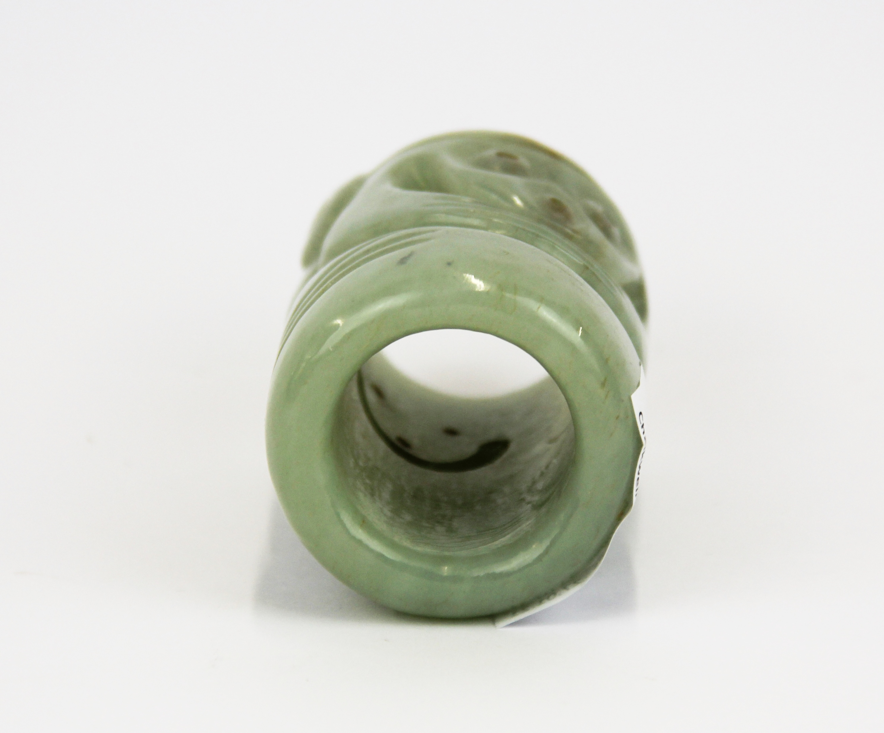 An unusual Chinese carved pale celadon russet jade cylinder decorated with two mask like faces, H. - Image 2 of 2