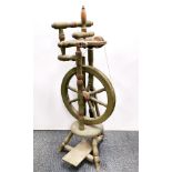 A painted pine spinning wheel, H. 92cm.