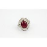 A 925 silver ring set with a large oval cut ruby surrounded by white stones, (N.5).
