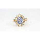A yellow metal (tested high carat gold) cluster ring set with a 2.31ct cornflower sapphire