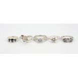 Five 925 silver stone set rings.