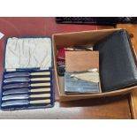 A box of mixed vintage cutlery and other items.
