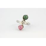 A French 18ct white gold ring set with a brilliant cut diamond and pink and green cabochon cut